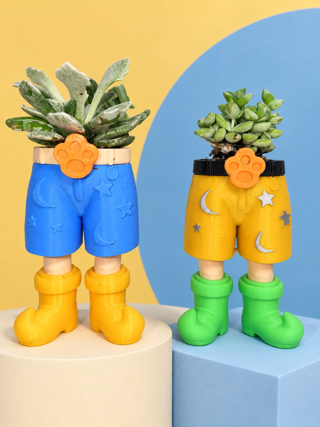 Blue and yellow Weekender shorts planters on studio platforms, with yellow and green boots