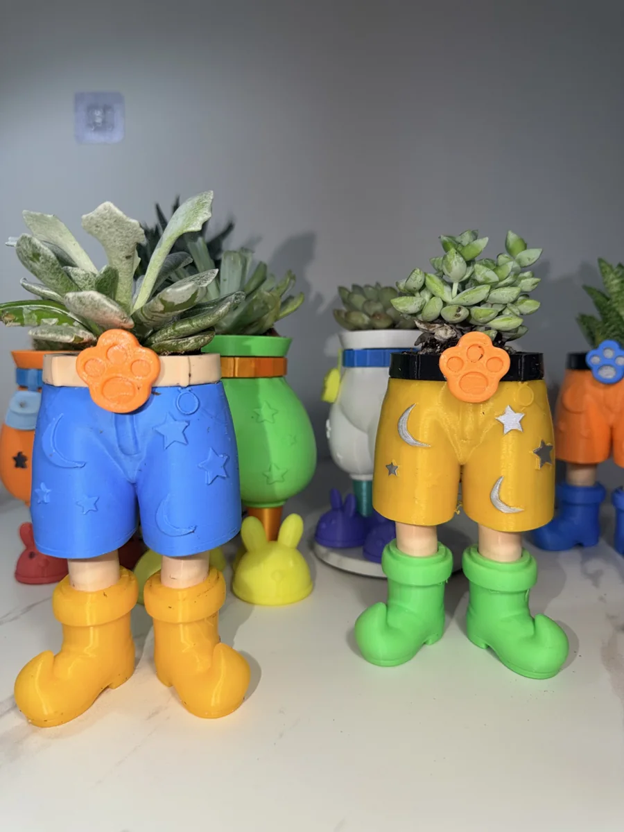 Original photograph of blue shorts with yellow boots beside yellow shorts with green boots