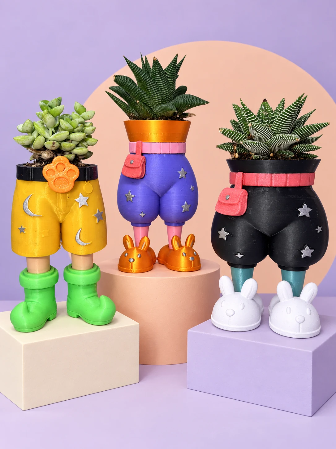 Black Big Chill planter beside purple pants and yellow Weekender shorts with succulents